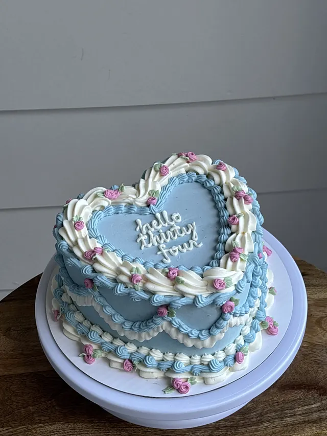 Blue heart cake with ivory piping, pink roses and "hello thirty four."