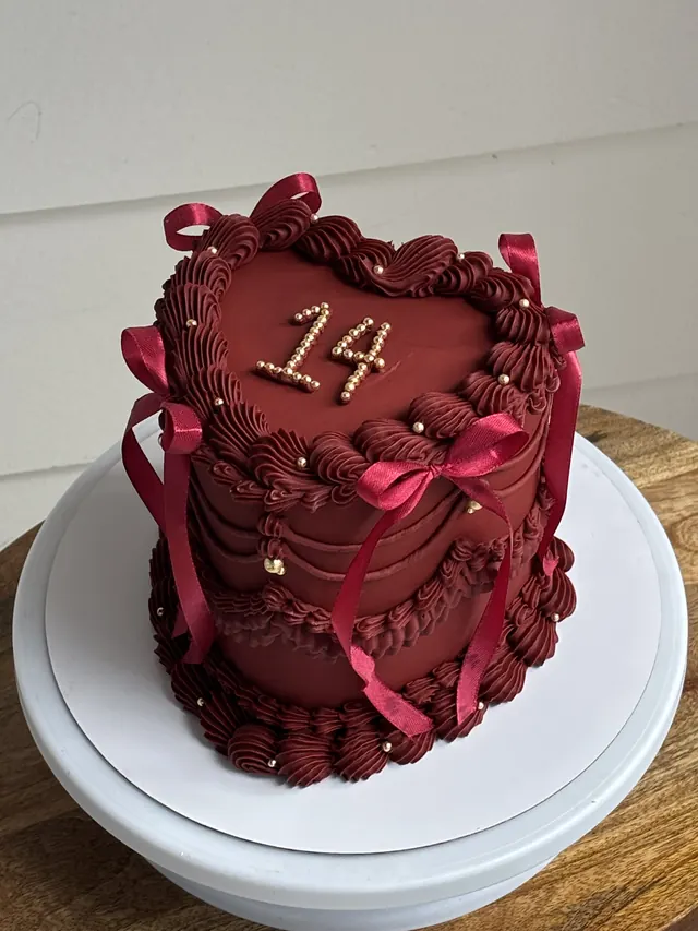 Tall burgundy heart cake with pearls, burgundy bows and a pearl 14