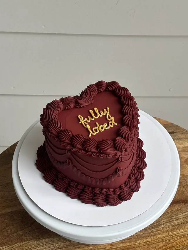 Burgundy heart cake with "fully lobed" in gold