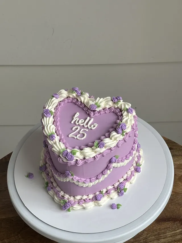 Lavender heart cake with purple flowers and "hello 25."