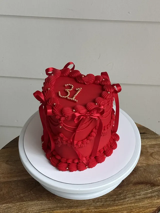 Tall red heart cake with red bows, pearls and a pearl 31