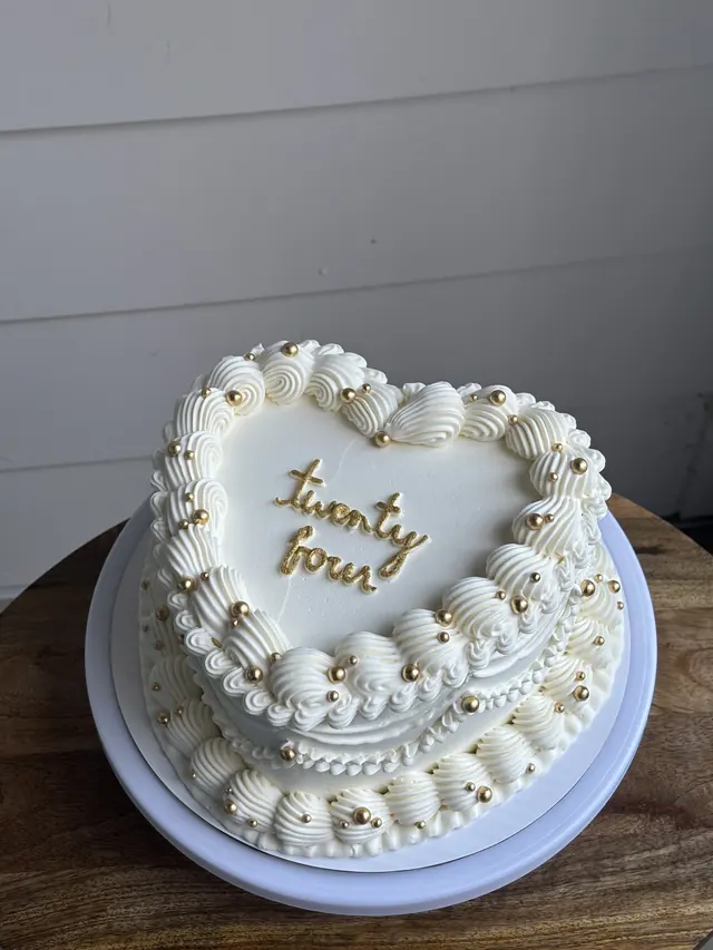 Small ivory heart cake with gold pearls and "twenty four" in gold