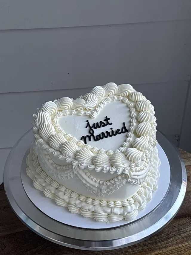 Ivory heart cake with pearl borders and "just married."