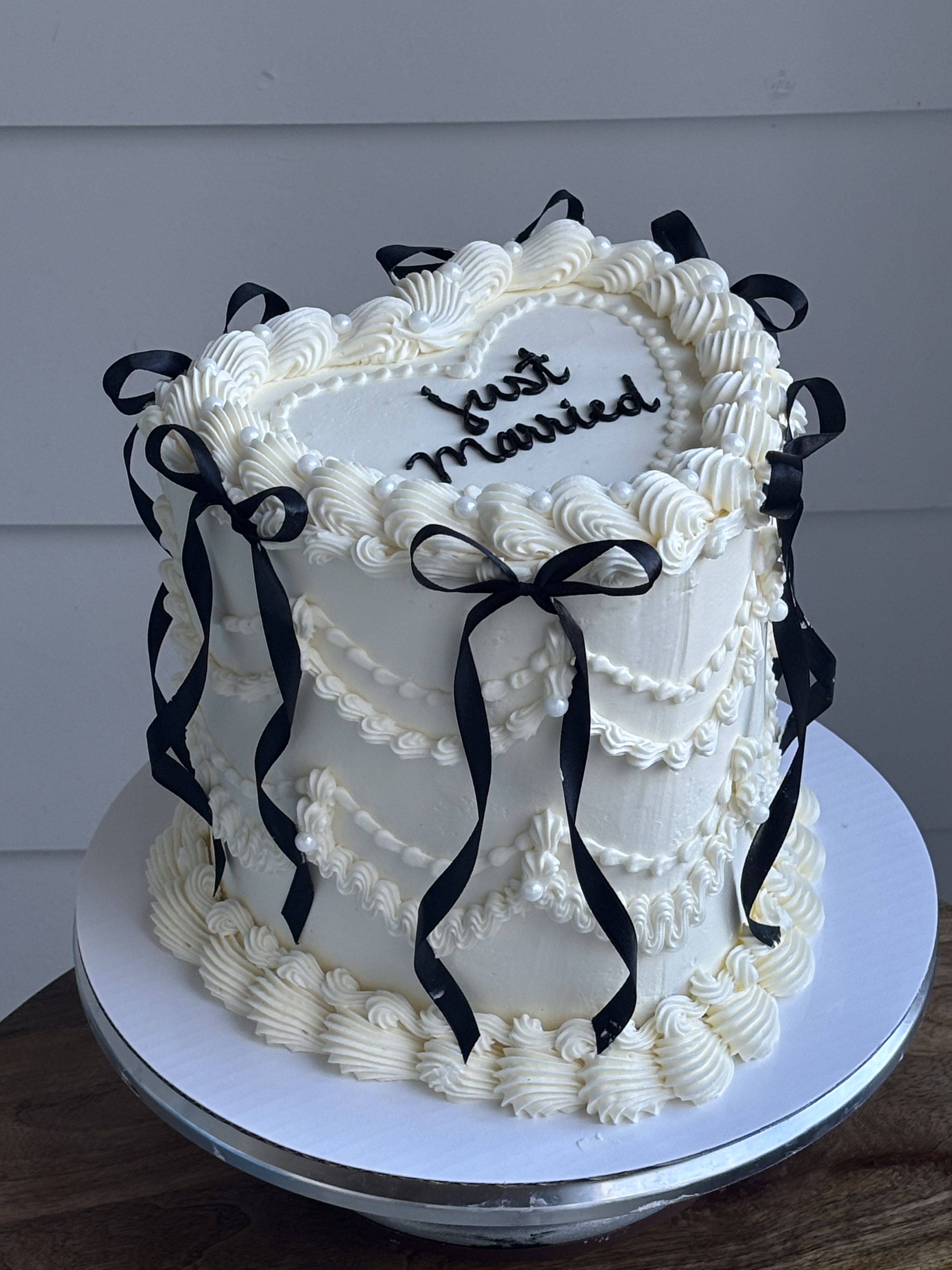 White just married tall heart cake